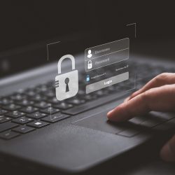 Hand typing on keyboard laptop computer to input username and password for or technology security system and prevent hacker concept.